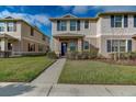 This is a charming two-story townhome with a well-maintained lawn and welcoming front entrance at 1567 Dawnview Way, Kissimmee, FL 34744