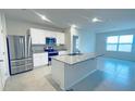 Bright kitchen featuring granite countertops, stainless steel appliances, and an island at 1727 Buckeye Rd, Davenport, FL 33837