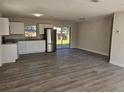 Spacious kitchen featuring stainless steel appliances, white cabinetry, and wood grain floors at 2209 Sw 6Th St, Ocala, FL 34471