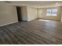 Bright and airy living room featuring wood grain flooring, a large window, and a front door at 2209 Sw 6Th St, Ocala, FL 34471