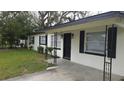 A well-manicured lawn compliments this charming home with black shutters and freshly painted trim at 2411 Nansen Ave, Orlando, FL 32817