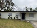 Charming single-story home with a well-maintained front yard and a decorative black front door at 2411 Nansen Ave, Orlando, FL 32817