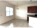 Bright dining area with a large window and stylish light fixture at 2523 Salzburg Loop, Winter Haven, FL 33884