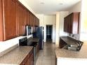 Spacious kitchen featuring plentiful cabinets, granite countertops, and stainless steel appliances at 2523 Salzburg Loop, Winter Haven, FL 33884