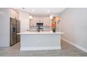 Bright kitchen with stainless steel appliances, a large island, pendant lights, and modern finishes at 2609 Sw 154Th Lane, Ocala, FL 34473