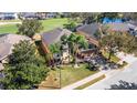 Aerial view of home showcasing golf course community, landscaping, and water view at 280 Del Sol Ave, Davenport, FL 33837