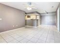 Bright and airy living room featuring tile flooring, neutral paint, and a ceiling fan at 3004 Parkway Blvd # 202, Kissimmee, FL 34747