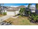 Well-maintained home with a two-car garage and manicured lawn and landscaping at 331 Henley Cir, Davenport, FL 33896