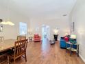 Bright living room featuring hardwood floors, neutral walls, and comfortable seating areas with stylish decor at 331 Henley Cir, Davenport, FL 33896