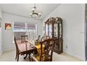 Dining room featuring a wooden table and chairs set beneath a decorative chandelier at 3414 Willow Branch Ln, Kissimmee, FL 34741