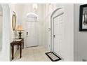 Bright entryway featuring neutral tile flooring, white walls, and decorative lighting at 3414 Willow Branch Ln, Kissimmee, FL 34741