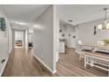 The hallway features nice vinyl floors and gray walls with access to the bedrooms and kitchen at 3642 Doe Run Dr, St Cloud, FL 34772