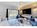 Bright living room features modern wood accent wall, recessed lighting, and sliding glass doors to the outdoors at 3939 Calabria Ave, Davenport, FL 33897