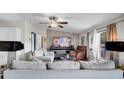 Inviting living room with neutral decor, a stone accent wall, and comfortable seating arrangements at 415 N Winter Park Dr, Casselberry, FL 32707