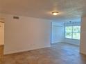 Bright living area with tile flooring and a closet, offering ample space at 5116 Conroy Rd # 12, Orlando, FL 32811