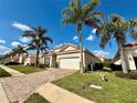 Charming single-story home with a tile roof, lush landscaping, and a two-car garage at 650 Tuscan Hills Blvd, Davenport, FL 33897