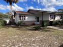 Inviting single-story home with a manicured lawn and mature palm tree in the front yard at 710 E Arizona Ave # A, Deland, FL 32724