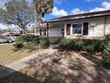 Single-story home with landscaped front yard, green shrubbery, and concrete walkway at 710 E Arizona Ave # A, Deland, FL 32724