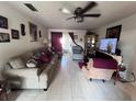 Spacious living room with tile floors, ceiling fan and sliding glass doors leading to outdoor patio at 710 E Arizona Ave # A, Deland, FL 32724