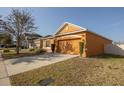 Charming one-story home featuring a well-manicured lawn and a two-car garage at 714 Franklin Ct, Haines City, FL 33844