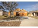 Charming single-story home with an attached two-car garage and manicured front yard at 714 Franklin Ct, Haines City, FL 33844