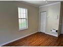 Bedroom featuring light laminate flooring, a large window, and a closet at 727 Siena Palm Dr, Celebration, FL 34747