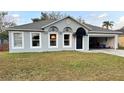 Charming single-story home with a grey exterior, complemented by a well-manicured front yard and driveway at 856 Jarnac Dr, Kissimmee, FL 34759