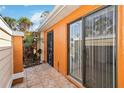 Private patio featuring tile flooring and a sliding glass door at 11 Silver Falls Cir, Kissimmee, FL 34743