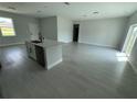 Open-concept living area with sleek flooring and abundant natural light at 113 Dogwood Drive Circle, Ocala, FL 34472