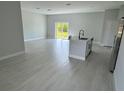Open concept living room featuring a sliding glass door, and an island with a sink at 113 Dogwood Drive Circle, Ocala, FL 34472