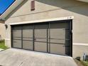 Close up of the garage with a three-car garage door at 144 Bella Dr, Davenport, FL 33837