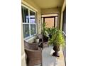 Screened patio with potted plants and wicker furniture at 144 Bella Dr, Davenport, FL 33837