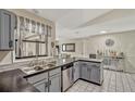 Modern kitchen featuring gray cabinets, stainless steel appliances, and sleek black countertops at 1464 Howland Blvd, Deltona, FL 32738