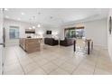 Open-concept living room featuring tile flooring, recessed lighting, and access to the outdoor patio at 194 Aidans Lndg, Haines City, FL 33844