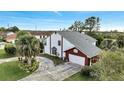 Aerial view of white two-story home with gray roof and attached garage at 2462 Albany Dr, Kissimmee, FL 34758