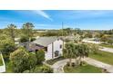 An aerial view of a two-story white home with a gray roof and lush landscaping at 2462 Albany Dr, Kissimmee, FL 34758