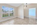 Bright living room featuring tile flooring and a large window offering natural light at 2938 Foraker Way, Kissimmee, FL 34758