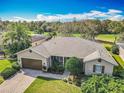 Beautiful single Gathering home with a manicured lawn, paired with a brown garage door and lovely landscaping at 328 Hamrick Dr, Kissimmee, FL 34759