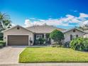 Charming single-story home featuring a well-maintained lawn and an attached two-car garage with a brick-paved driveway at 328 Hamrick Dr, Kissimmee, FL 34759