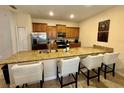 Kitchen island featuring granite countertop and bar seating at 4875 Clock Tower Dr, Kissimmee, FL 34746