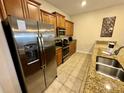 Well-equipped kitchen featuring stainless steel appliances and granite countertops at 4875 Clock Tower Dr, Kissimmee, FL 34746