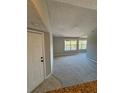 Spacious living room featuring large windows that provide ample natural light and plush carpeting at 5152 Conroy Rd # 1333, Orlando, FL 32811