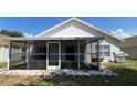 Enclosed back porch with tiled floors and screened windows overlooks the backyard at 525 Garberia Dr, Davenport, FL 33837