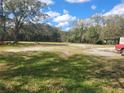 Expansive yard featuring ample space for outdoor activities and relaxation, enhanced by lush greenery and shade trees at 610 Buckley Dr, Kissimmee, FL 34741