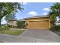 Charming single-story home featuring a well-manicured lawn and a two-car garage at 651 Glendora Rd, Kissimmee, FL 34759