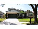 Charming one-story home features lush landscaping, a well-manicured lawn, and a tile roof at 7670 Milano Dr, Orlando, FL 32835