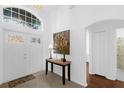 Bright foyer featuring a decorative glass window above the entrance and a stylish marble-top console table at 816 Garden Glen Loop, Lake Mary, FL 32746