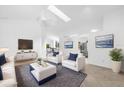 Bright living room with skylight, sleek furnishings, neutral tones, and modern decor, enhancing the spacious feel at 816 Garden Glen Loop, Lake Mary, FL 32746