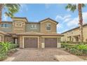 Charming two-story townhome with a brick driveway, attached garage, and beautiful landscaping at 8946 Azalea Sands Ln # 8946, Davenport, FL 33896