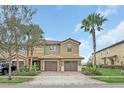 Charming two-story townhome with a brick driveway, attached garage, and lush landscaping at 8946 Azalea Sands Ln # 8946, Davenport, FL 33896